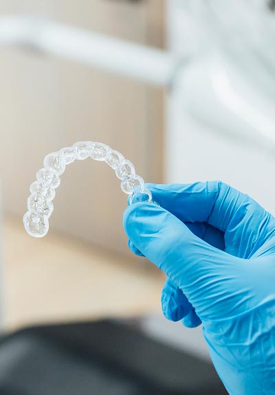 Dr. Welch holding Invisalign clear aligners