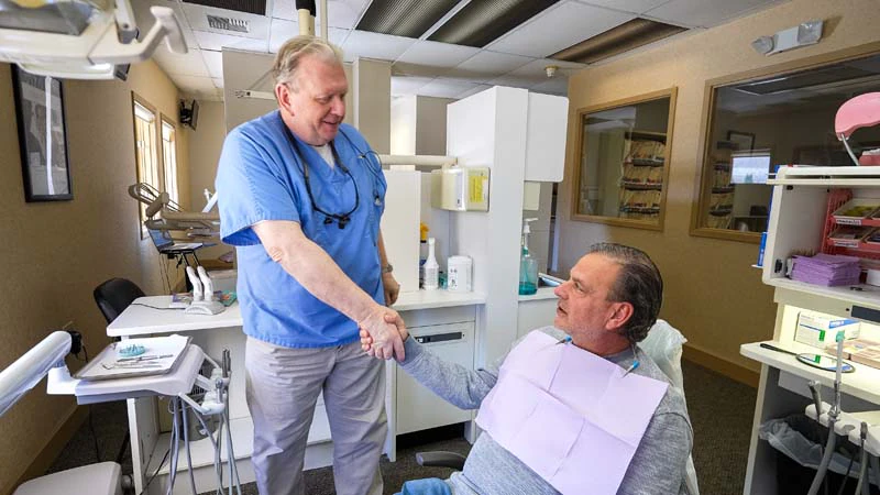 Dr. Kevin Welch shaking hands with a patient after discussing dental crown options at Family Dental Practice in Kokomo IN. 