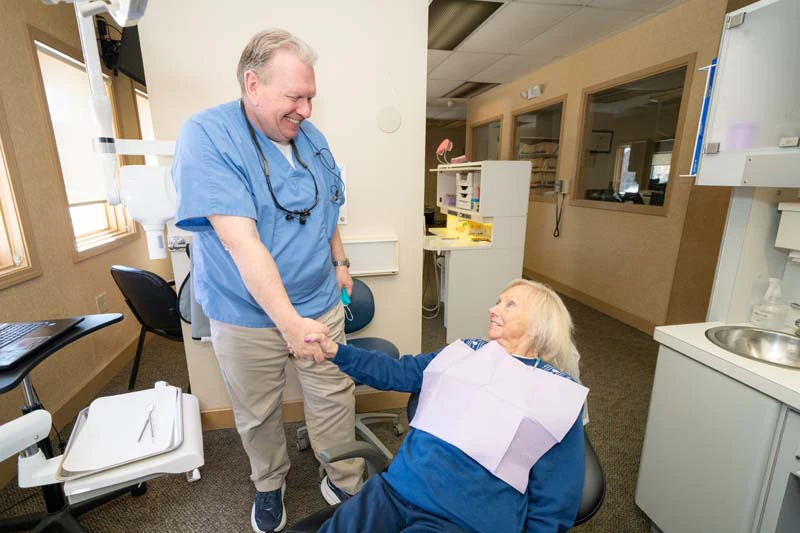 Dr. Kevin Welch with a female patient discussing denture options at Family Dental Practice in Kokomo IN. 
