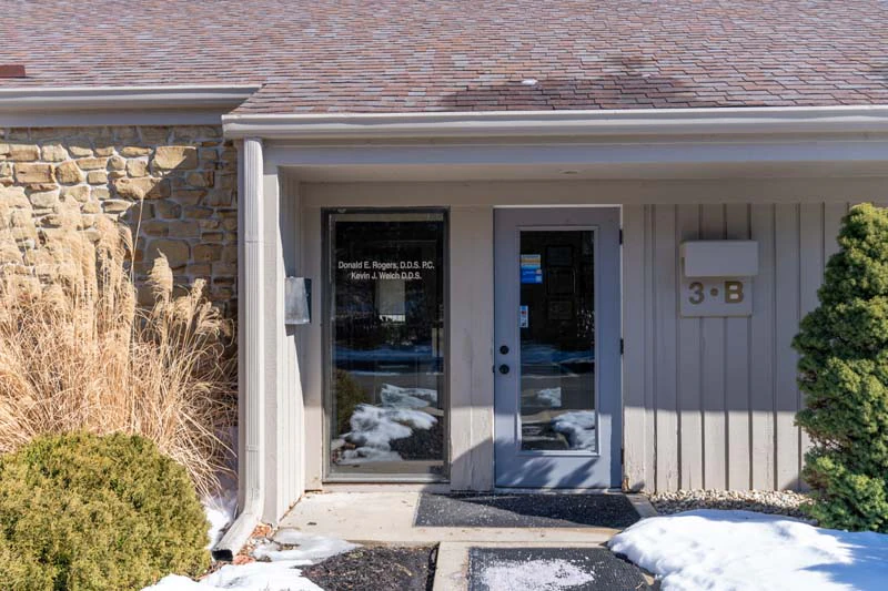 An outdoor photo of Family Practice Dentistry in Kokomo IN with snow on the ground and plants.