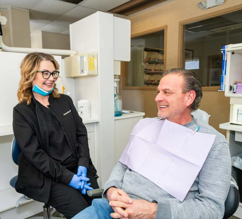 Staff member with a patient discussing preventative dental procedures at Family Dental Practice in Kokomo IN.